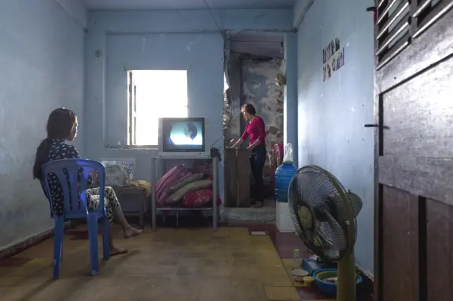 Mother and daughter inside an apartment