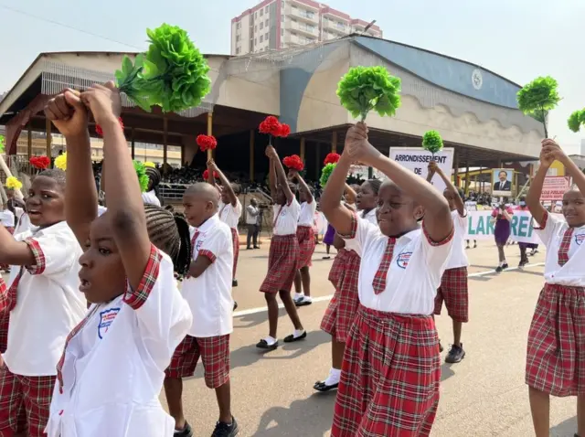 Students in uniform march with matching batons in Yaoundé, Cameroon - Friday 11 February 2022