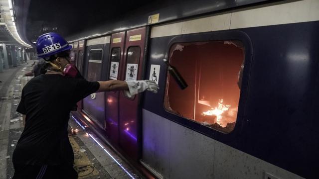 HONG KONG, CHINA - NOVEMBER 13: Pro-democracy protesters set fire to an MTR train car during a demonstration at Chinese University of Hong Kong on November 13, 2019 in Hong Kong, China. Anti-government protesters organized a general strike since Monday as demonstrations in Hong Kong stretched into its sixth month with demands for an independent inquiry into police brutality, the retraction of the word "riot" to describe the rallies, and genuine universal suffrage.