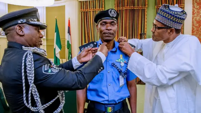 President Buhari decorate di new Inspector-General of Police, Abubakar Adamu Mohammed Tuesday afternoon for Aso rock.
