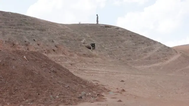 جنديان يقفان بالقرب من نفق في منطقة جبلية