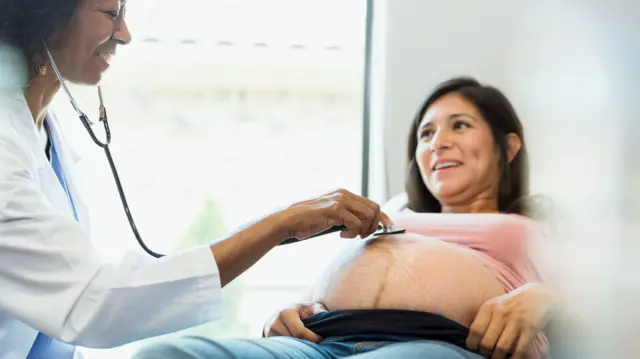 Médica examinando paciente grávida