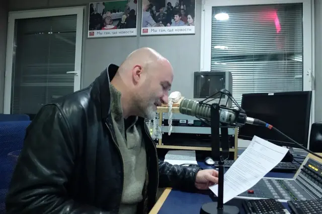 мушкарац у радијском студију ББЦ-ја, радијски водитељ