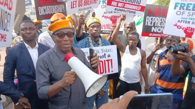 An activitist, Sowore on orange beret, a man on white singlet