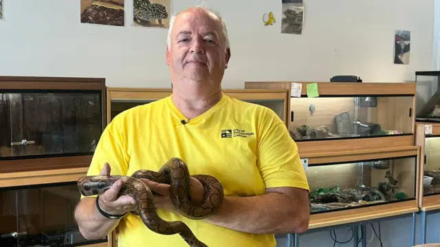 Pete Quinlan holding a snake
