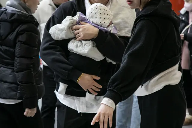 Couple holding a baby 