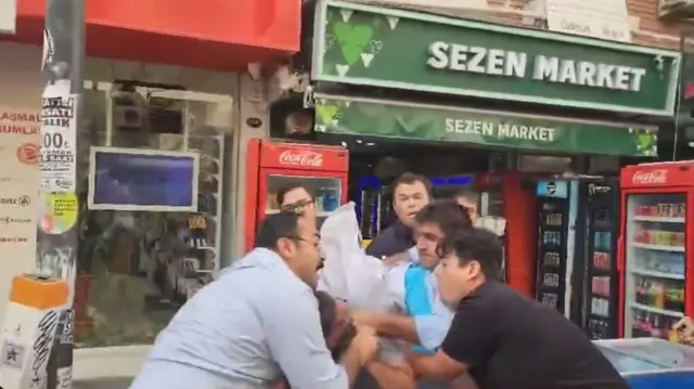 Bir erkeğin başına çuval geçiriliyor
