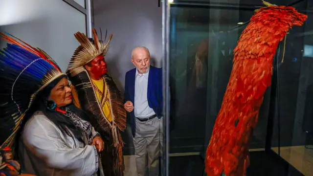 O presidente do Brasil, Luiz Inácio Lula da Silva, acompanhado pela ministra dos Povos Indígenas, Sonia Guajajara, observa o manto tupinambá — uma capa cerimonial de penas utilizada em rituais religiosos — durante uma cerimônia no Museu Nacional do Brasil, no Rio de Janeiro, em 12 de setembro de 2024.