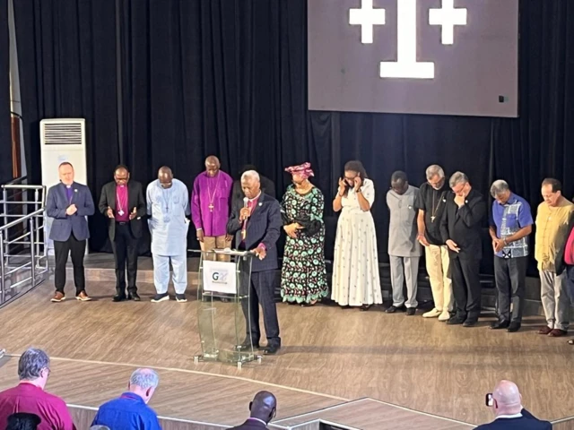 New leader dey speak wit people behind am during di Gafcon meeting for Abuja to elect new leader