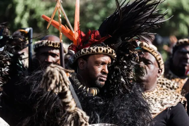 King of Amazulu nation Misuzulu kaZwelithini (C) stand wit Amabutho (Zulu regiments) during im coronation for di KwaKhangelamankengane Royal Palace for Kwa-Nongoma