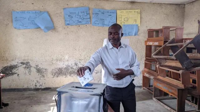 Un homme met son bulletin dans l'urne