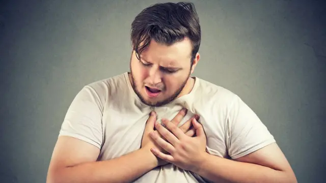 An actor simulating a heart attack