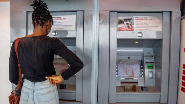 Customer dey use automated teller machine (ATM) for Lagos, Nigeria