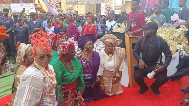 Awọn obinrin ti wọn ro dẹdẹ kan dudu kunlẹ niwaju Ewi ilu Ado Ekiti.