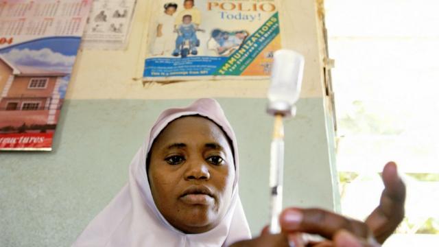 Una mujer prepara una vacuna contra la polio.
