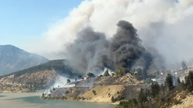 A view of Lytton burning from across the Fraser River