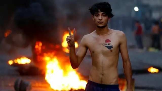 متظاهر يرفع يده بعلامة النصر في احتجاجات يوم 27 يوليو/تموز