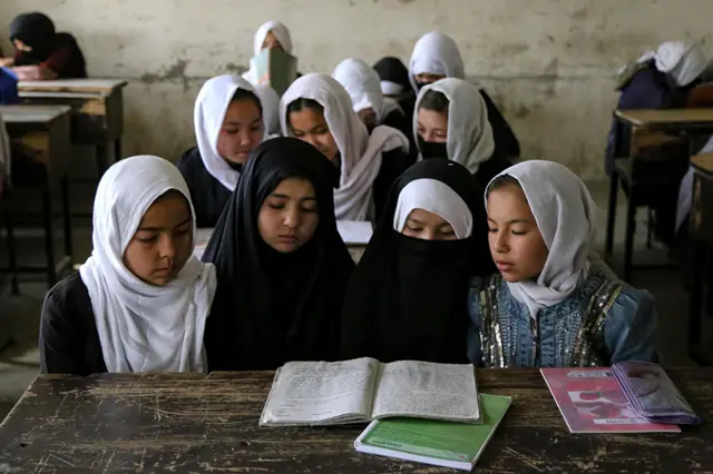 primary schoolgirls sit in a classroom at the start of the new academic year in Kabul, Afghanistan, 25 March 2023