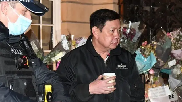 Myanmar ambassador to UK Kyaw Zwar Minn speaks to police officers after trying and failing to enter Myanmar's embassy in Mayfair, London