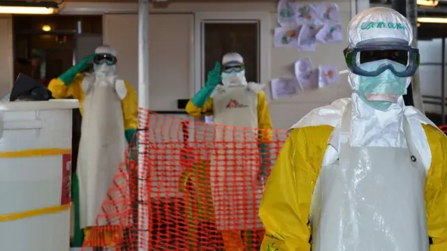 Health workers wear protective gear for di Nongo Ebola treatment centre for Conakry, Guinea, on August 21, 2015