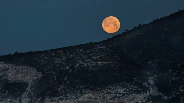 Blue Moon from the village of Sant Elm, in Majorca Island, eastern Spain, early 31 March 2018.