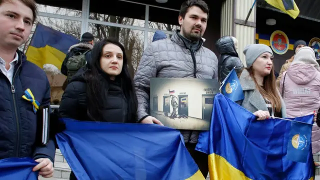 People attend a rally to support the Ukrainian navy after Russia seized two Ukrainian armored artillery vessels and a tug boat in the Kerch Strait , in Odessa