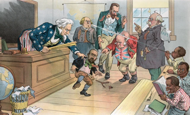 Un salón de clase en la que hay un maestro que tiene una regla de madera en una mano y en la otra agarra del saco a una figura más pequeña con barba que dice “Castro”. En el salón hay un grupo de niños nativos y cuatro hombres mayores blancos, que se ven molestos, tienen etiquetas que dicen: Holanda, Francia, Inglaterra y Alemania. 