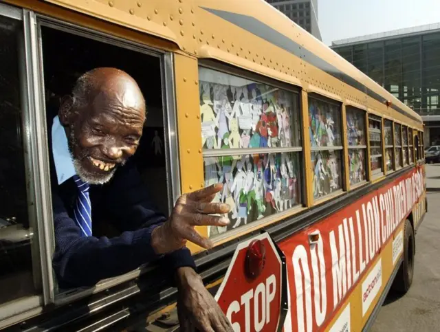 An elderly student Kimani Maruge on a bus
