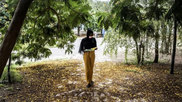 A Student wears a face mask as she studies on her first day back at Chiekh Anta Diop University in Dakar on September 1, 2020.