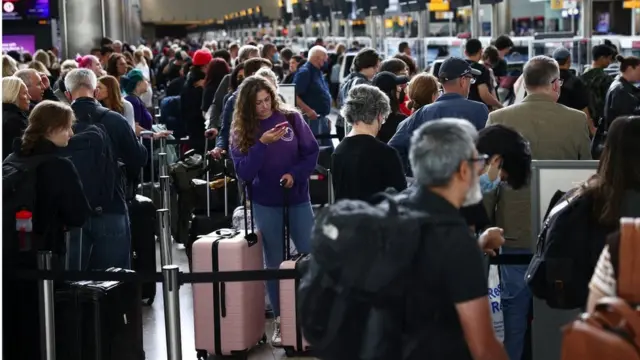 Passengers queue inside the departures terminal of Terminal 2 at Heathrow Airport in London, Britain, June 27, 2022. REUTERS/Henry Nicholls/File Photo