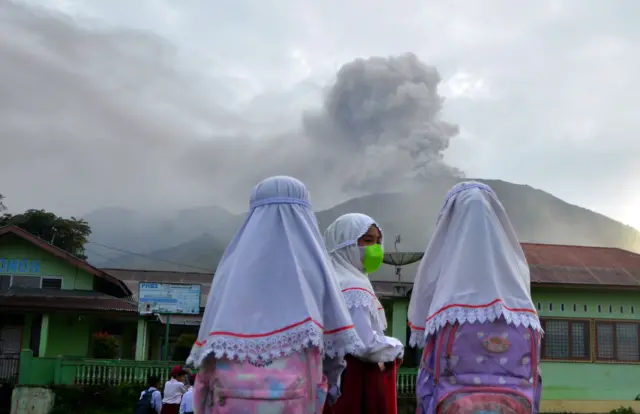 Students at school as Mount Marapi spews volcanic ash, as seen from Nagari Batu Palano in Agam, West Sumatra province, Indonesia