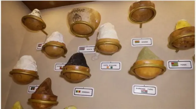 Calabash wey dem hang for wall with sheabutter inside.