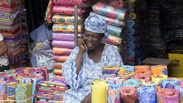 Market woman wey dey sell ankara