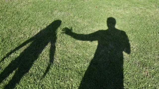 Silueta de un hombre y un niño.