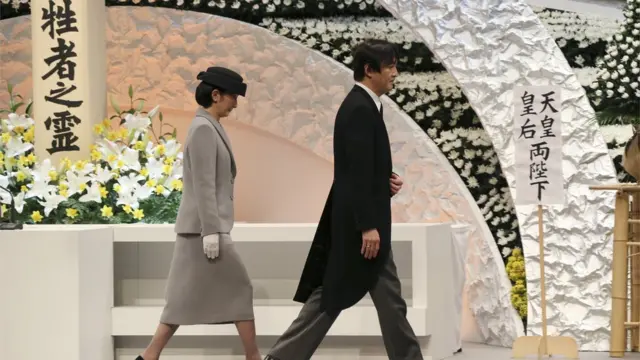 Japanese Prince Akishino and Princess Kiko walk in front of the altar for victims of the March 11, 2011 earthquake and tsunami after the prince delivered a speech at the national memorial service in Tokyo on March 11, 2017.
