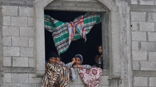 ከስምምነቱ በኋላ ፍልስጤማዊያን ከጋዛ በመስኮት በኩል ሲመለከቱ