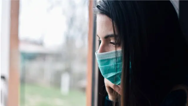 Woman looks through a window