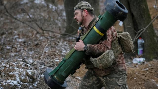 A Ukrainian service member holds a Javelin missile system at a position on the front line in the north Kyiv region, Ukraine March 13, 2022