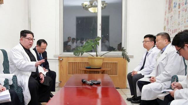 This April 23, 2018 picture released by North Korea"s official Korean Central News Agency (KCNA) on April 24, 2018 shows North Korean leader Kim Jong-Un (L) speaking to Chinese Ambassador to North Korea Li Jinjun (2nd R) while visiting a hospital where Chinese tourists injured in a bus accident were being treated