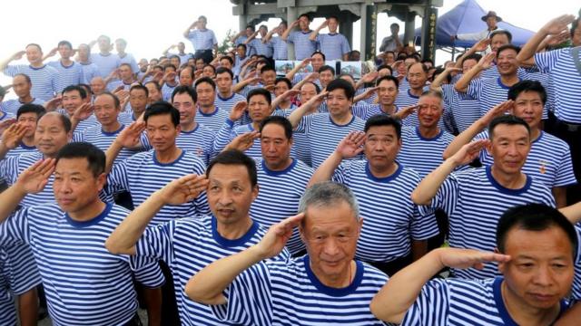 2017年建军节前，老兵在河南洛阳向国旗敬礼。