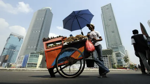 A food vendor takes advantage of the 'Car Free Day' as he sets up his business on a main street in downtown Jakarta