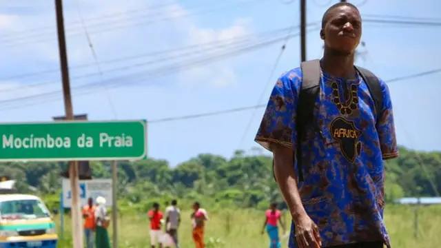 A man walks by the main entrance to the city on March 8, 2018 in Mocimboa da Praia, Mozambique