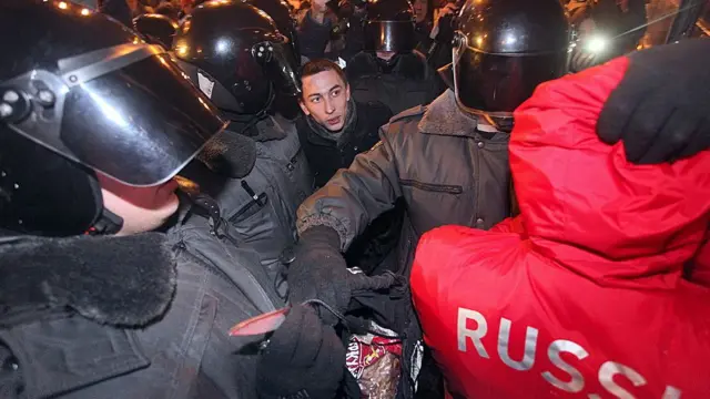 Policías rusos arrestando a un aficionado.