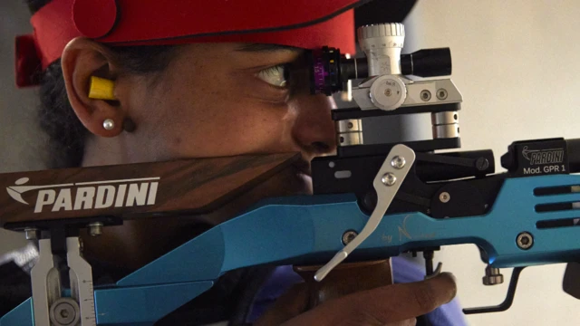 Luna Solomon pointing an air rifle in Lausanne, Switzerland - Sunday 23 May 2021