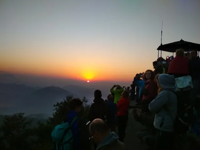 सूर्योदय हेर्दै पर्यटकहरू