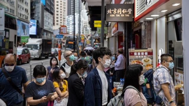 Coronavirus outbreak 2020: Hong Kong - people queue for takeaway outside a restaurant as eating inside restaurants is banned following increased infections
