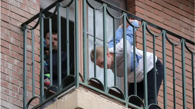 A woman does exercises on the balcony at a block of flats at Lyotchika Ivana Fyodorova Street, Moscow region