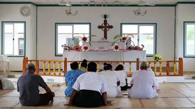 Personas sentadas en el suelo sobre alfombras de yute. Tuvalu