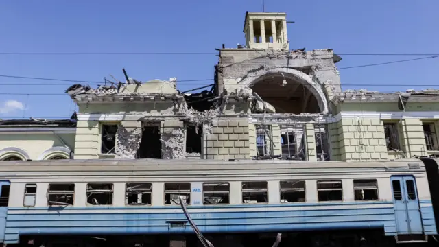 A damaged train and a bombed railway station in the town of Lozova in Ukraine.
