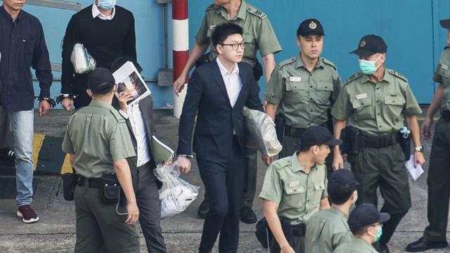Pro-independence protestor Edward Leung (C) leaves the Lai Chi Kok Reception Centre for the High Court for sentencing on rioting and assaulting a police officer in Hong Kong on June 11, 2018, for his part in the 'fishball riots' that took place in February 2016.